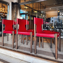Load image into Gallery viewer, Red chairs in a restaurant window display with reflections of the interior.
